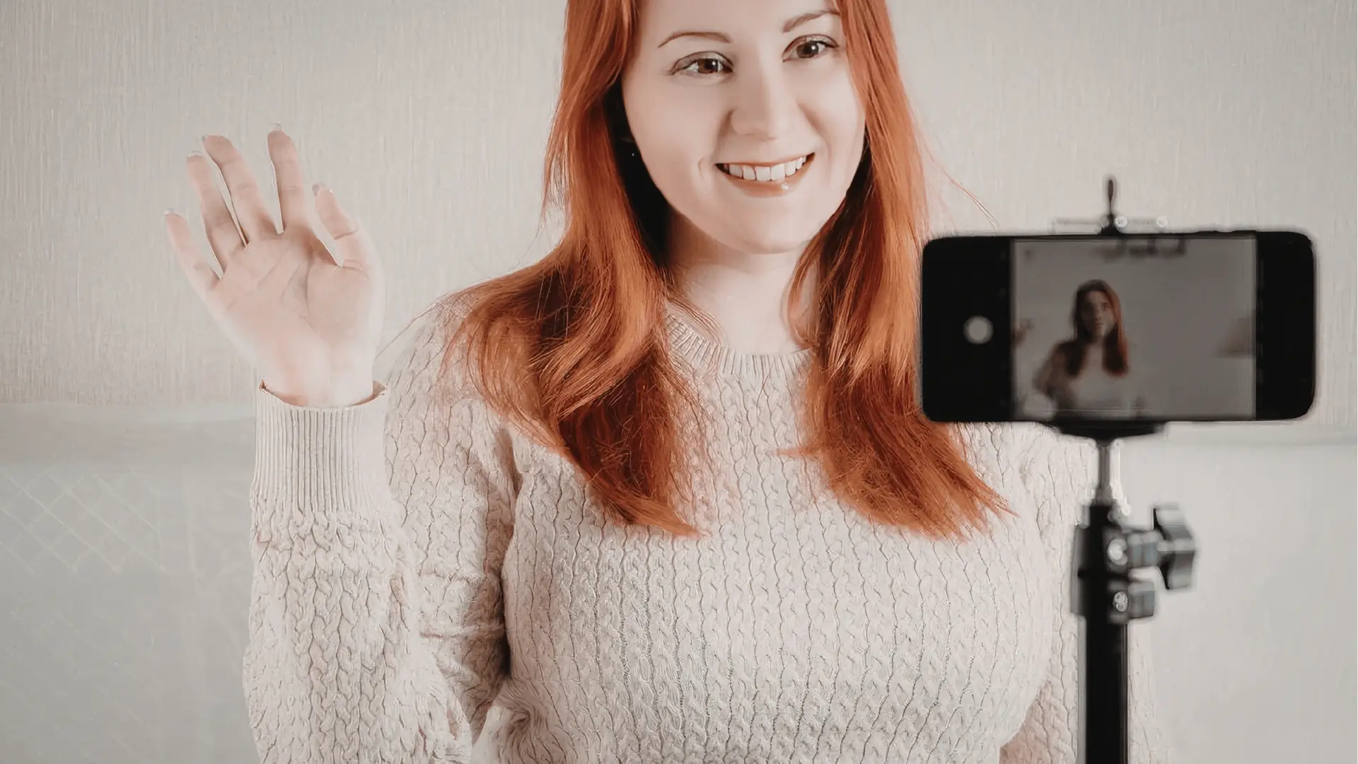 A marketer reviews a digital dashboard showing social media analytics charts and engagement metrics.