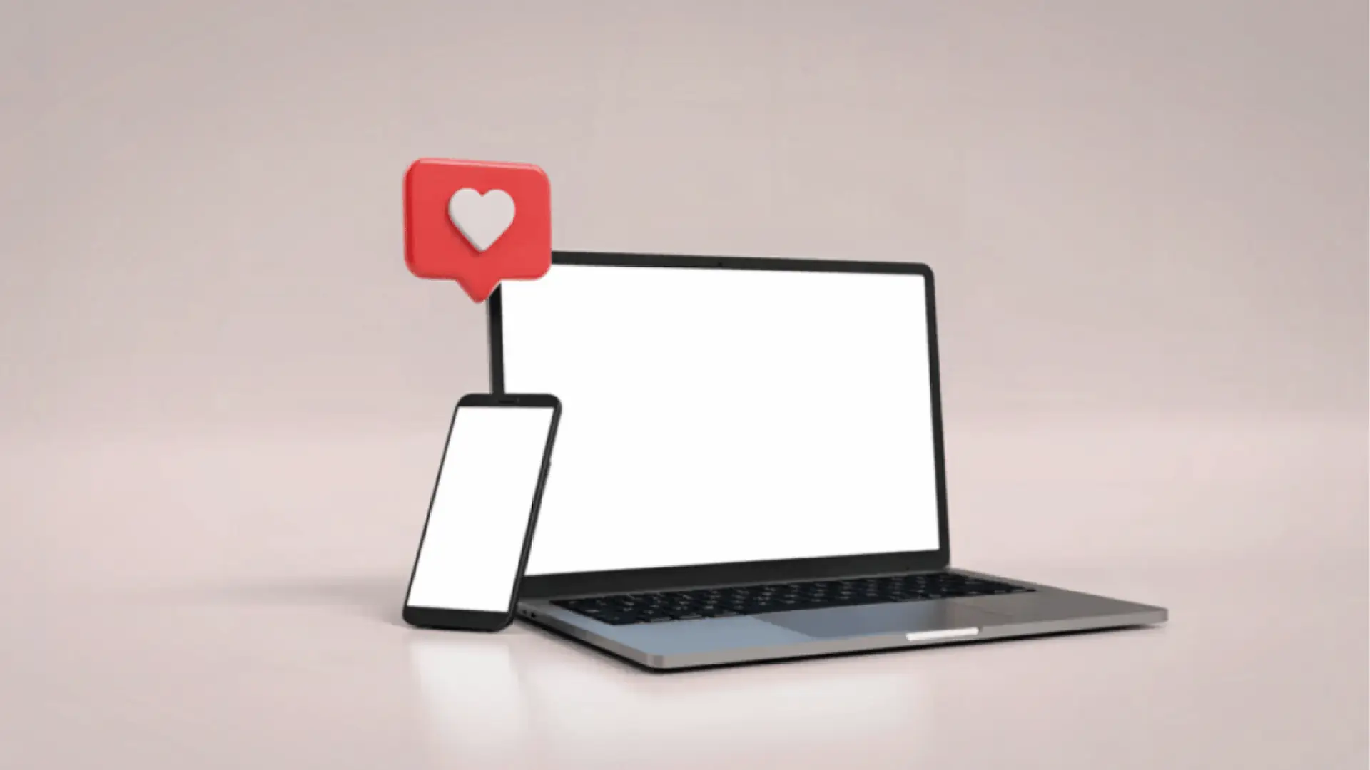 Laptop and smartphone with blank screens and red heart notification icon for content calendar