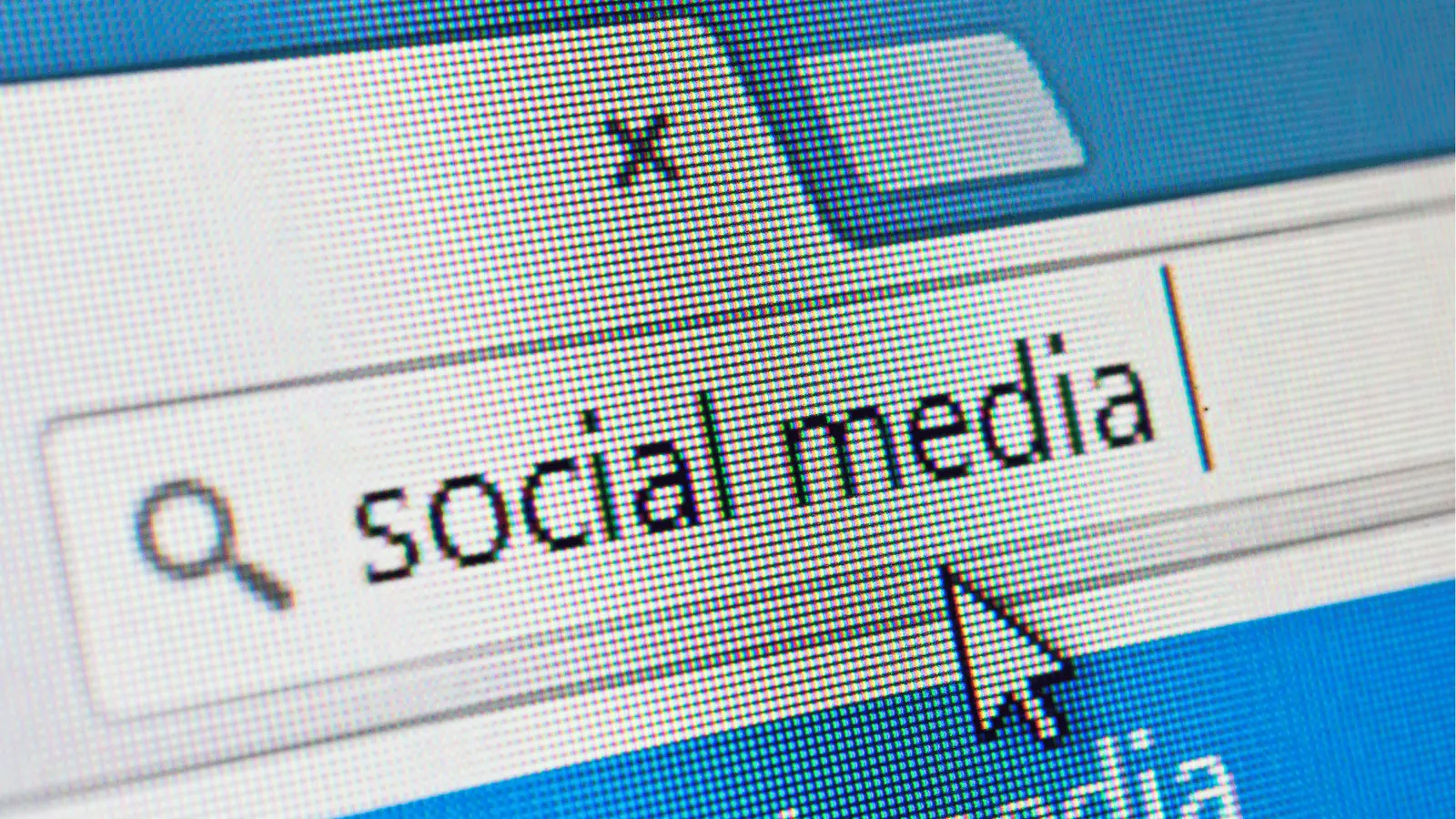 Macro computer screen showing a search field with the words social media
