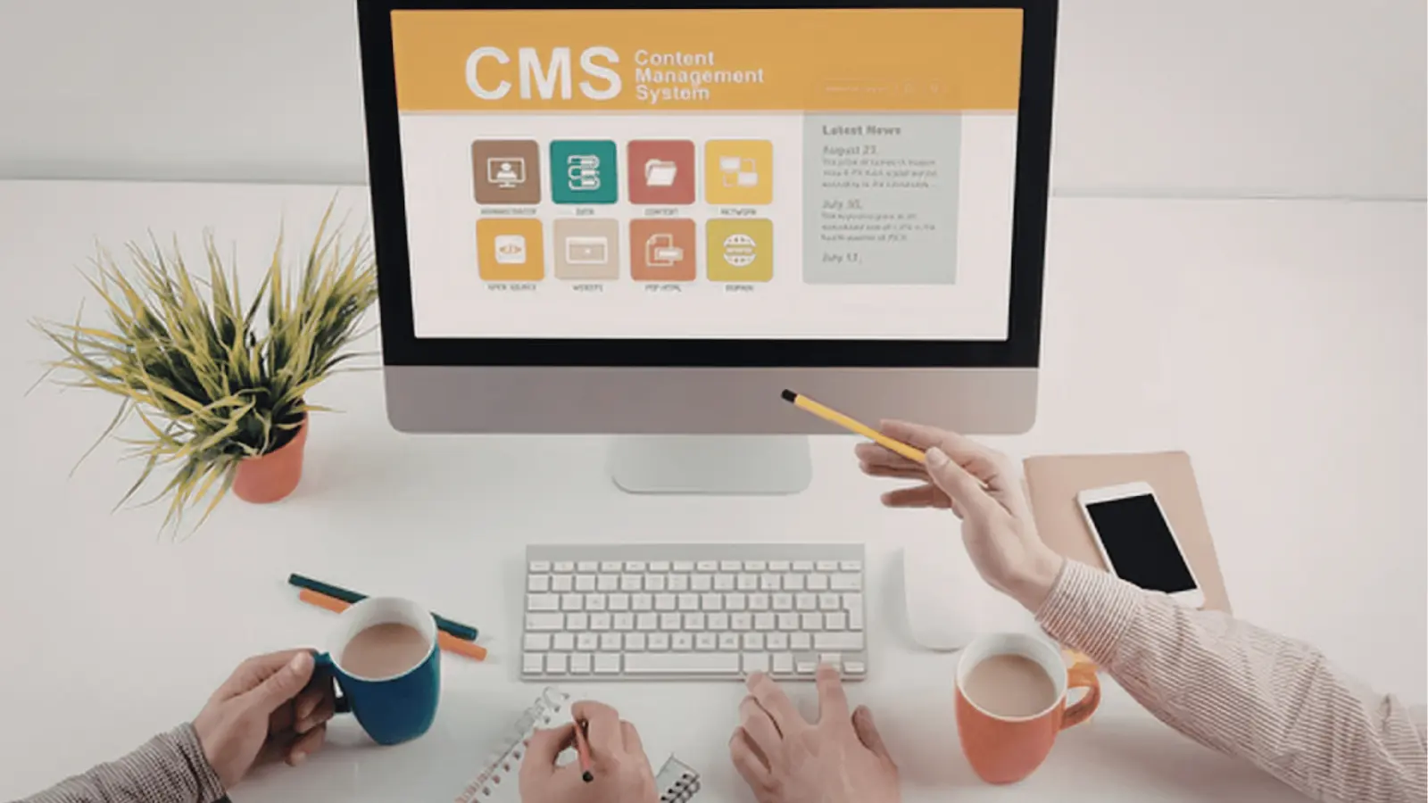 Desktop computer showing CMS screen on a tidy desk with hands and coffee for inbox management