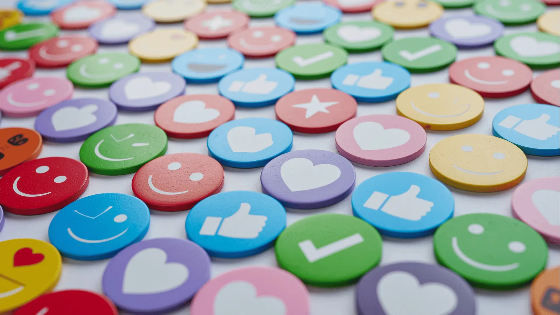 Rows of colorful round tokens showing hearts, thumbs and smiley icons for scheduling