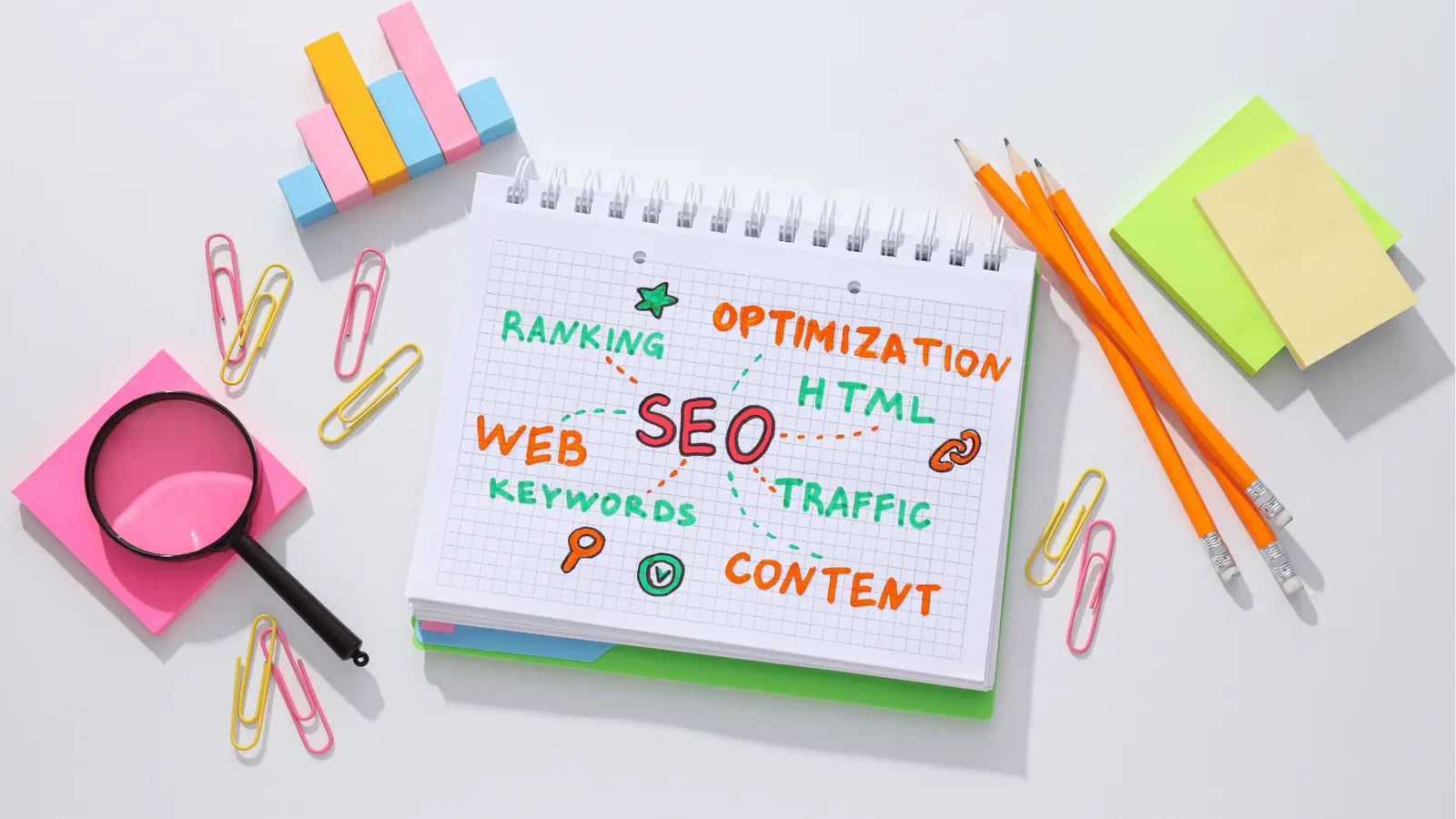 Overhead view of notebook with colorful SEO doodles and stationery for inbox management