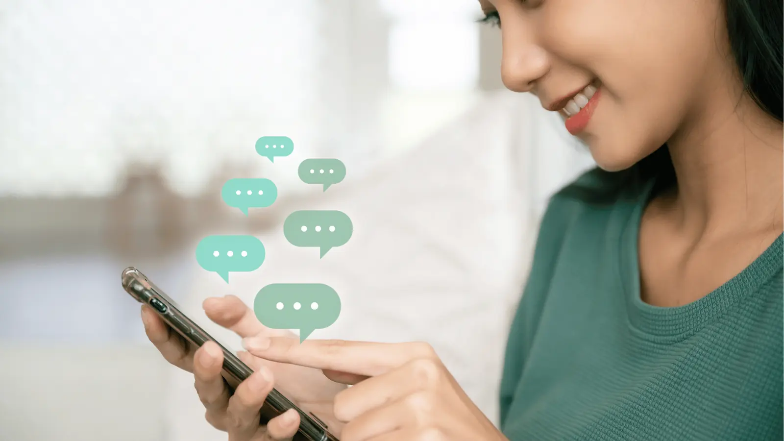 Woman smiling and typing on smartphone with floating chat icons